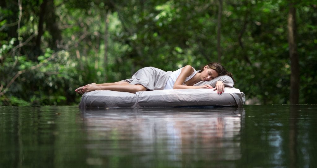 redefine your approach to sleep, woman floating on mattress